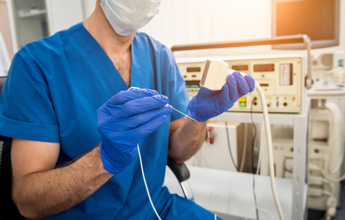 Picture of a male Medical Professional sitting next to a Electrophysiology or EP.